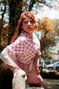 Confident woman posing stylishly in a pink checkered outfit, surrounded by urban scenery in Mexico City.